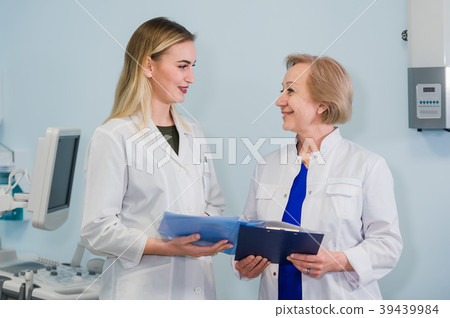 Senior doctor talking with young woman assistant Senior doctor talking with young woman assistant 39439984