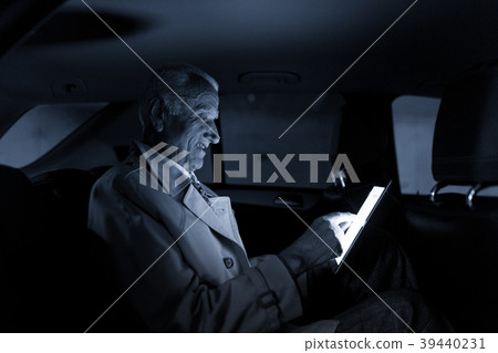 Businessman with a digital tablet sitting in the Businessman with a digital tablet sitting in the 39440231