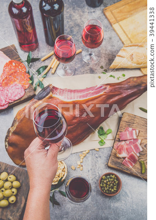 Mans hand holding wine glass frome above table Mans hand holding wine glass frome above table 39441338