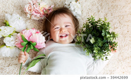 Happy toddler boy with spring flowers Happy toddler boy with spring flowers 39442699