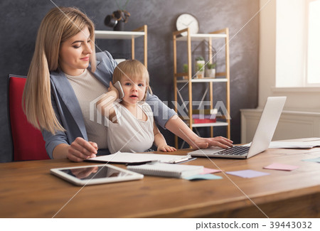 Young working mother spending time with baby 39443032