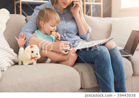 Young mother working and spending time with baby 39443038