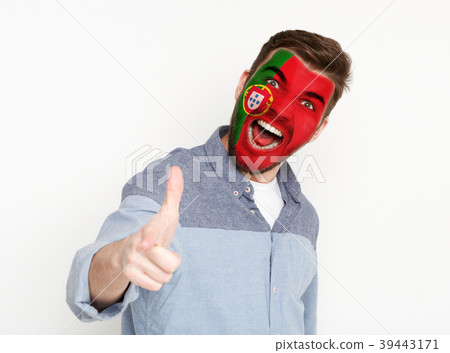 Young man with Portugal flag painted on his face Young man with Portugal flag painted on his face 39443171