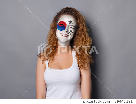 Young woman with Korea flag painted on her face Young woman with Korea flag painted on her face 39443181