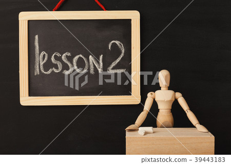 Lesson 2 written with chalk on blackboard. Lesson 2 written with chalk on blackboard. 39443183