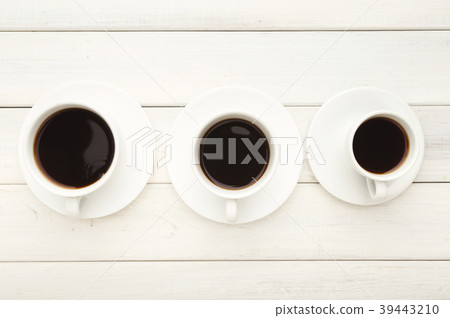 Various cups with black coffee on white wooden Various cups with black coffee on white wooden 39443210