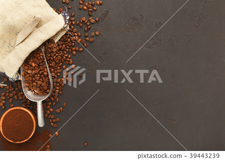 Coffee beans scattering from burlap sack on gray Coffee beans scattering from burlap sack on gray 39443239