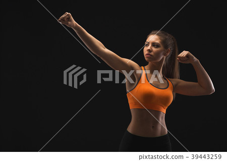 Athletic woman showing muscular body 39443259