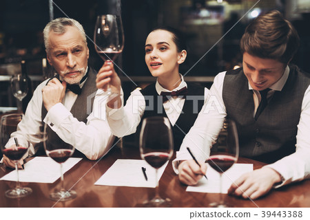 Beautiful female sommelier holding glass of wine 39443388