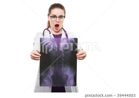 Attractive young woman doctor holding x-ray making Attractive young woman doctor holding x-ray making 39444883