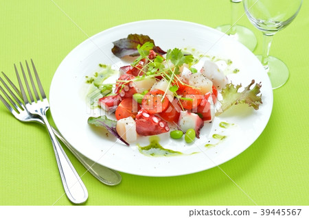 Marinated octopus and scallops with basil sauce. Italian-style appetizer, hors d'oeuvres. With white wine. 39445567