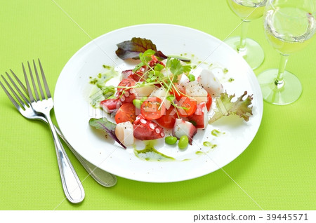 Marinated octopus and scallops with basil sauce. Italian-style appetizer, hors d'oeuvres. With white wine. 39445571