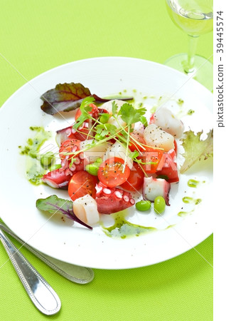 Marinated octopus and scallops with basil sauce. Italian-style appetizer, hors d'oeuvres. With white wine. 39445574