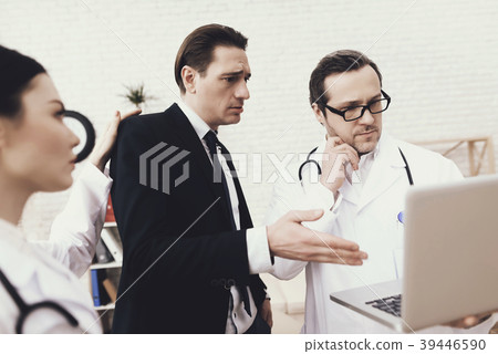 Anxious businessman looks at laptop screen Anxious businessman looks at laptop screen 39446590