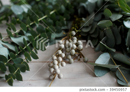Eucalyptus leaves on a wooden white table Eucalyptus leaves on a wooden white table 39450957