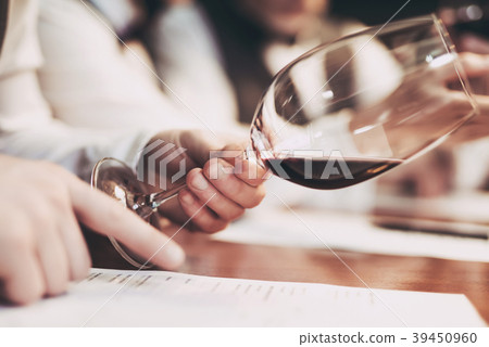 Man's hand holds glass of red wine Man's hand holds glass of red wine 39450960