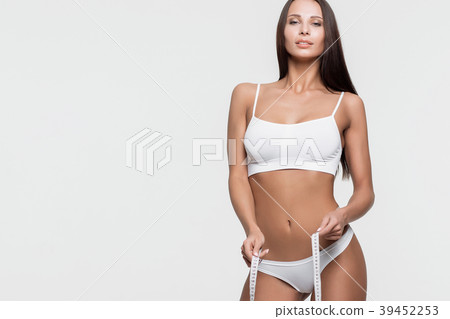 Young beautiful girl measures your body parts of 39452253