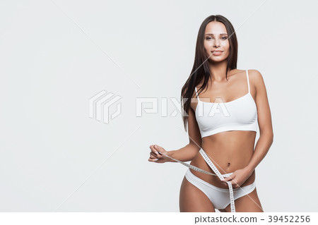 Young beautiful girl measures your body parts of 39452256