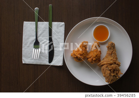 Fried chicken and sauce on a white plate low light 39456285