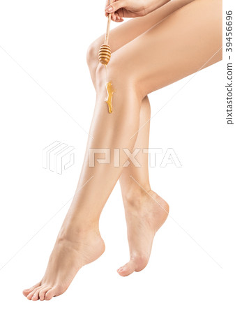 Female legs depilation by honey or sugar pasta. 39456696