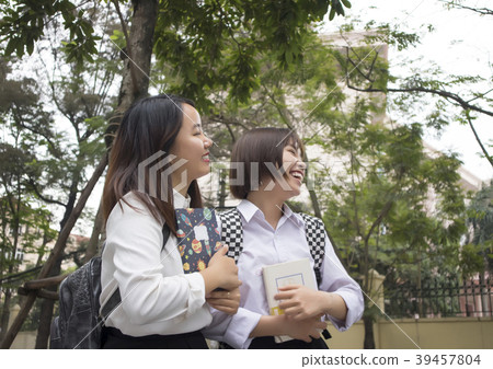 two girls on the street looking up two girls on the street looking up 39457804
