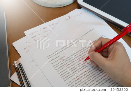 proofreading paper on wooden desk proofreading paper on wooden desk 39458200