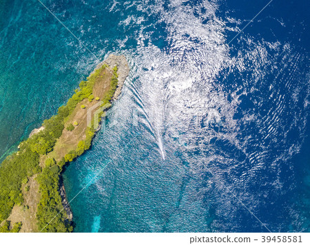 Island in the Ocean and a Boat Trimaran. Aerial Island in the Ocean and a Boat Trimaran. Aerial 39458581