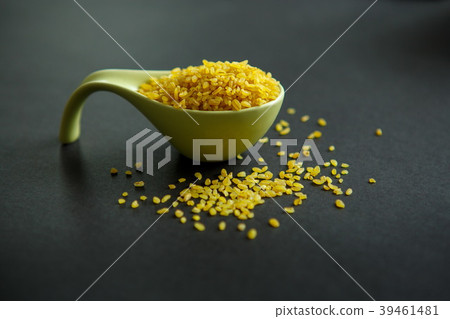 Bulgar, cereals on a black background in a bowl Bulgar, cereals on a black background in a bowl 39461481