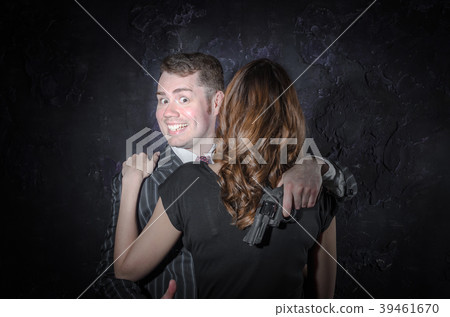 An actor detective with a gun smiling and taking 39461670