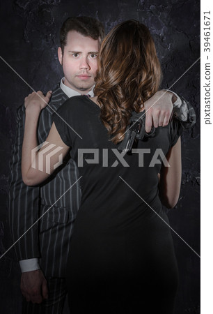 A detective with a gun and his beautiful woman in 39461671