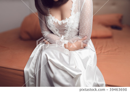 Woman in nightwear suffering from abdominal pain Woman in nightwear suffering from abdominal pain 39463698