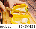Female person slicing yellow bell pepper 39466484
