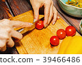 Female person slicing cherry tomatoes 39466486