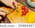 Young female person slicing green olives for salad 39466487
