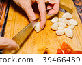 Female person slicing garlic for cooking 39466489