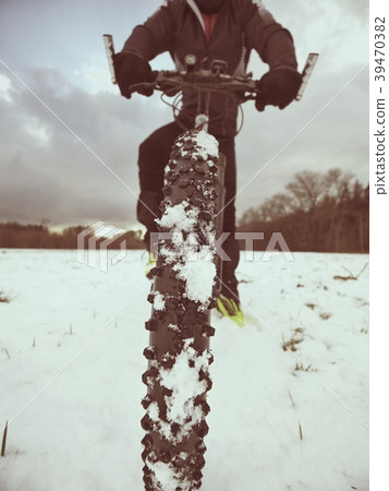 Cyclist man with winter bike stays in snow. Cyclist man with winter bike stays in snow. 39470382