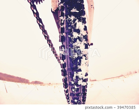 Rear wheel of mtb. Snow flakes on off road tyre Rear wheel of mtb. Snow flakes on off road tyre 39470385