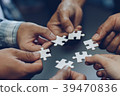 The jigsaw image shows cooperation. Help and Teamw 39470836