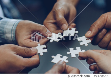 The jigsaw image shows cooperation. Help and Teamw The jigsaw image shows cooperation. Help and Teamw 39470836