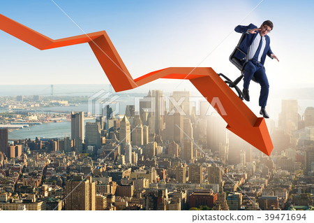 Businessman sliding down on chair in economic 39471694