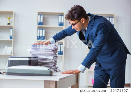 Businessman making copies in copying machine 39471807
