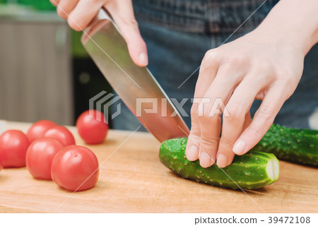 close-up of female hands cut into fresh cut 39472108