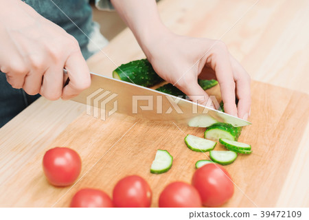 close-up of female hands cut into fresh cut 39472109