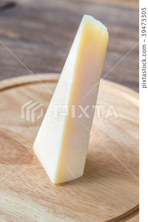 Grana Padano cheese on the wooden board Grana Padano cheese on the wooden board 39473305