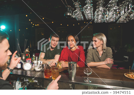 Glad friends speaking at counter 39474551