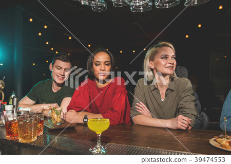 Cheerful man talking with two happy girls Cheerful man talking with two happy girls 39474553