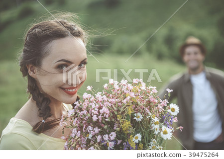 Optimistic attractive girl is dating on meadow 39475264