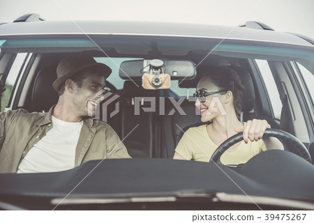 Cheerful lovers are using vehicle for travel 39475267