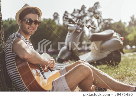 Joyful guy performing song in nature Joyful guy performing song in nature 39475480