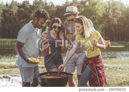 Rejoicing young company roasting beer snacks in Rejoicing young company roasting beer snacks in 39476035